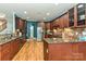 Spacious kitchen with granite countertops, wooden cabinets, and stainless steel appliances plus hardwood flooring at 1467 Kensington Park Ct, Hickory, NC 28602