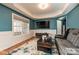 The living room showcases coffered ceilings, hardwood flooring, a gray couch, and modern decor at 1467 Kensington Park Ct, Hickory, NC 28602