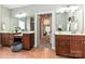 The dual vanities in the main bathroom are brightly lit and complemented by dark wood cabinetry at 1467 Kensington Park Ct, Hickory, NC 28602