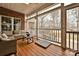 Covered outdoor patio featuring wood floors, comfortable couches and chairs, and screened-in porch at 1467 Kensington Park Ct, Hickory, NC 28602