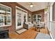 Relaxing covered patio featuring comfortable seating, ceiling fan, and brick exterior at 1467 Kensington Park Ct, Hickory, NC 28602