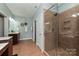 The tiled shower is the focal point of this main bath, with glass door and corner shelf at 1467 Kensington Park Ct, Hickory, NC 28602