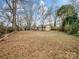 Large backyard with mature trees and open space at 1500 Collier Ct, Charlotte, NC 28205