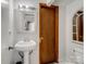 Simple bathroom with pedestal sink, mirror, and toilet at 1500 Collier Ct, Charlotte, NC 28205