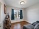 Cozy bedroom featuring hardwood floors and a large window at 1500 Collier Ct, Charlotte, NC 28205