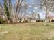 Ranch style home with a large front yard and mature trees at 1500 Collier Ct, Charlotte, NC 28205