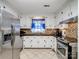 Kitchen features white cabinets, granite counters, and stainless steel appliances at 1500 Collier Ct, Charlotte, NC 28205