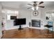 Living room with hardwood floors, fireplace and large TV at 1500 Collier Ct, Charlotte, NC 28205