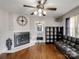 Cozy living room with fireplace, hardwood floors, ceiling fan and modern decor at 1500 Collier Ct, Charlotte, NC 28205