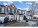 Brick front two-story townhome with attached garage and landscaping at 159 Kallie Loop, Mooresville, NC 28117