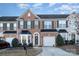 Brick front two-story townhome with attached garage and landscaping at 159 Kallie Loop, Mooresville, NC 28117