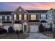 Brick front two-story townhome with attached garage and landscaping at 159 Kallie Loop, Mooresville, NC 28117