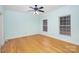 Light-painted bedroom with hardwood floors and ceiling fan at 1610 Elkhart Cir, Gastonia, NC 28054