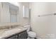 Clean bathroom with granite countertop, single sink vanity, and shower/tub combo at 1620 Arlyn Cir # G, Charlotte, NC 28213