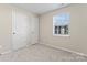 Bedroom with neutral walls, carpeting, and single window at 1620 #G Arlyn Cir, Charlotte, NC 28213