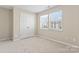 Spacious bedroom with neutral walls, carpeting, and double-door closet at 1620 Arlyn Cir # G, Charlotte, NC 28213