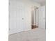 Spacious bedroom with neutral walls and carpet, featuring double closets and access to hallway at 1620 Arlyn Cir # G, Charlotte, NC 28213