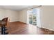 Bright dining area with hardwood floors and sliding glass door leading to balcony at 1620 Arlyn Cir # G, Charlotte, NC 28213