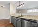 Gray cabinets, granite counters and stainless steel appliances in kitchen at 1620 Arlyn Cir # G, Charlotte, NC 28213