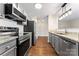 Modern kitchen with stainless steel appliances and hardwood floors at 1620 Arlyn Cir # G, Charlotte, NC 28213