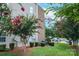 Exterior shot showing a condo building corner, with landscaping, foliage and flowering trees at 1620 Arlyn Cir # G, Charlotte, NC 28213