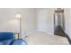 Cozy bedroom with a comfortable blue chair and natural light, creating a relaxing atmosphere at 1620 #G Arlyn Cir # G, Charlotte, NC 28213