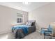 This bedroom features a bed with gray bedding and a window with natural light at 1620 #G Arlyn Cir # G, Charlotte, NC 28213