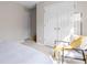 Bright bedroom with a cozy chair, throw blanket, and spacious closet provides comfortable living at 1620 #G Arlyn Cir # G, Charlotte, NC 28213