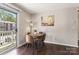 Bright dining area with a round table, four chairs, and natural light from the balcony doors at 1620 #G Arlyn Cir # G, Charlotte, NC 28213