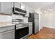 This modern kitchen has stainless steel appliances, granite counters and gray cabinets at 1620 #G Arlyn Cir # G, Charlotte, NC 28213