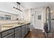 The kitchen has granite counters, a stainless steel dishwasher, and gray cabinets at 1620 #G Arlyn Cir # G, Charlotte, NC 28213