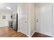 A kitchen and entryway features stainless steel appliances, gray cabinets, and hardwood floors at 1620 #G Arlyn Cir # G, Charlotte, NC 28213