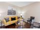 Cozy living room with a yellow couch, dark wood floors, and a decorative coffee table at 1620 #G Arlyn Cir # G, Charlotte, NC 28213