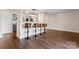 Spacious living area with a kitchen island and modern bar stools at 1620 #G Arlyn Cir # G, Charlotte, NC 28213