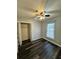 Bright bedroom with ceiling fan, large closet, and dark laminate floors at 1704 Fieldcrest Cir, Rock Hill, SC 29732