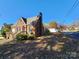 Side view of a brick home with a deck and yard at 19 Todd Ne Dr, Concord, NC 28025