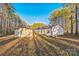 Rear view of house with detached garage, surrounded by trees at 1957 Beth Haven Church Rd, Denver, NC 28037