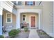 Inviting front entry with a red door and small patio at 206 River Clay Rd, Fort Mill, SC 29708