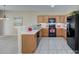 Modern kitchen with wood cabinets and black appliances at 206 River Clay Rd, Fort Mill, SC 29708