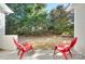 Private patio with two red chairs and view of trees at 206 River Clay Rd, Fort Mill, SC 29708