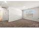 Well-lit bedroom with carpet, window, and neutral decor at 221 Wildflower Dr, Locust, NC 28097