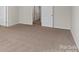 Large bedroom with plush carpeting and access to other rooms at 221 Wildflower Dr, Locust, NC 28097