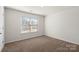 Simple bedroom with carpet, a window, and neutral walls at 221 Wildflower Dr, Locust, NC 28097