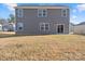 Two-story house with gray siding and backyard at 221 Wildflower Dr, Locust, NC 28097