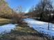 Snowy backyard with a small bush and clothesline at 2244 9Th Ne Ave, Hickory, NC 28601