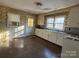 Kitchen with white cabinets and floral wallpaper at 2244 9Th Ne Ave, Hickory, NC 28601