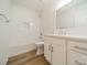 Clean bathroom with white vanity, bathtub, and tile shower surround at 2328 Sanders Ave, Charlotte, NC 28216