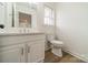 Updated bathroom with white vanity, toilet and vinyl flooring at 2328 Sanders Ave, Charlotte, NC 28216