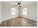 Well-lit bedroom with ceiling fan and wood-look floors at 2328 Sanders Ave, Charlotte, NC 28216