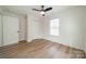 Bright bedroom with ceiling fan, wood-look floors, and a spacious closet at 2328 Sanders Ave, Charlotte, NC 28216